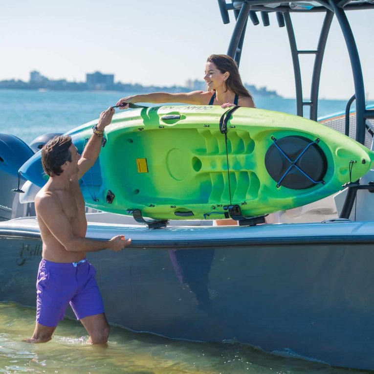 L2Klifestyle Man and woman storing their kayak in the Manta Racks L2K Kayak Storage Rack.