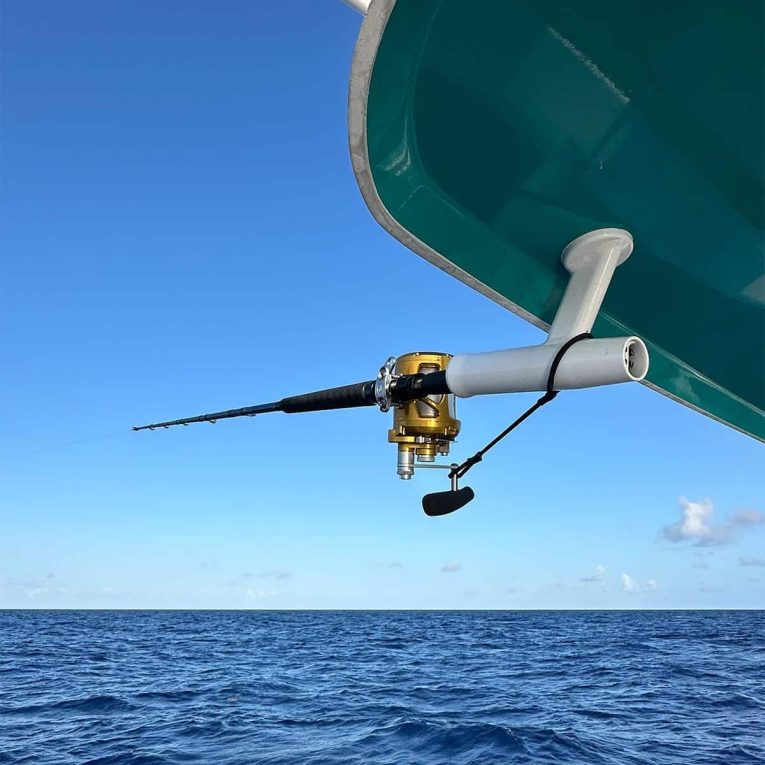 Rod-&-Reel-Leash-Boat-Side A boat in the ocean with a fishing rod and reel, equipped with Manta Racks Rod & Reel Leash.