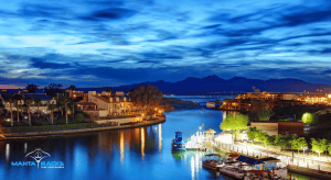 A peaceful Lake Havasu at night, with still waters mirroring the moon and stars in a tranquil atmosphere.
