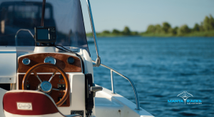 A boat featuring a prominent steering wheel, showcasing its navigational controls and design.