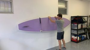 Loading a Surfboard onto a Wall Rack